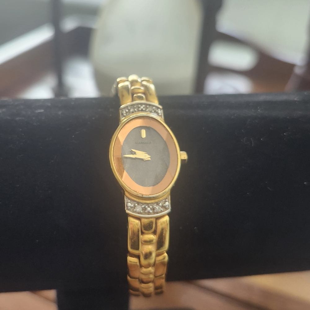 Gold and Black Analog Watch with Date Window